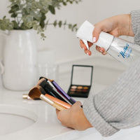 Person killing bacteria on make-up brushes using Nellie's Ninety-Nine