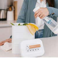 Person spraying Nellie's Ninety-Nine onto compost bin to remove odour