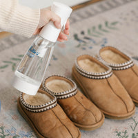 Person de-odourizing slippers using Nellie's Ninety-Nine