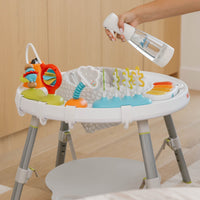 Person killing bacteria on baby activity center , using Nellie's Ninety-Nine