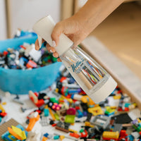 Person removing bacteria from kid's toys using Nellie's Ninety-Nine
