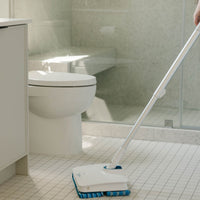 Person cleaning their bathroom floors with Nellie's Wow Mop