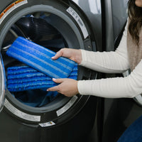 Person washing Nellie's Scrub & Polish Pads in their washing machine