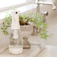 Nellie's One Bottle on kitchen counter with plant in background