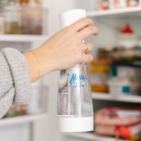 Person using Nellie's Ninety-Nine bottle