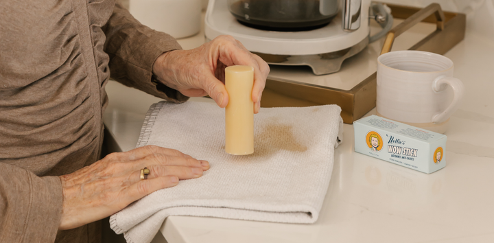 Removing a coffee stain from a dish towel with the WOW Stick. 