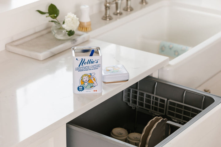 Nellie's Dishwasher Powder tin on counter above dishwasher.