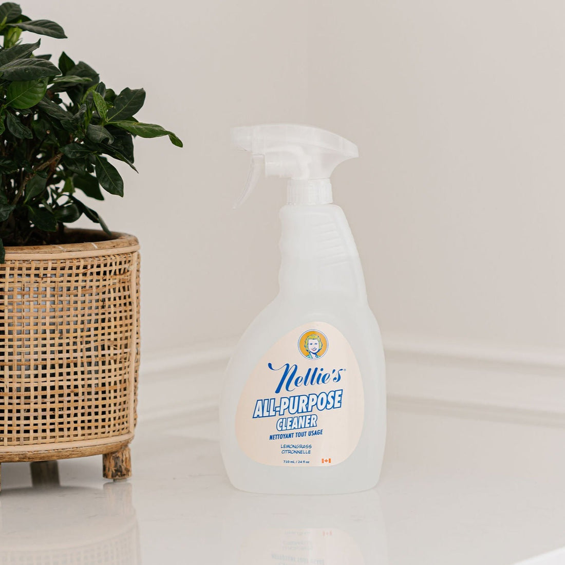Nellie's All-Purpose Cleaner with a refreshing lemongrass scent beside a plant