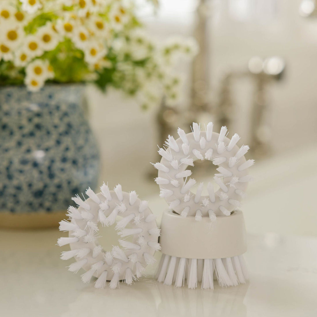 Dish Stick Replacement Heads on kitchen counter with flowers in the background