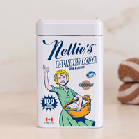 Nellie's Laundry Soda, Coconut scent, in a 100-load tin on a clean, white counter. 