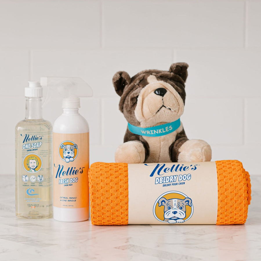 Pet Bundle laid on counter with pet towel, wrinkles stuffed toy, Fresh Dog spray, and fragrance free One saop for washing pets