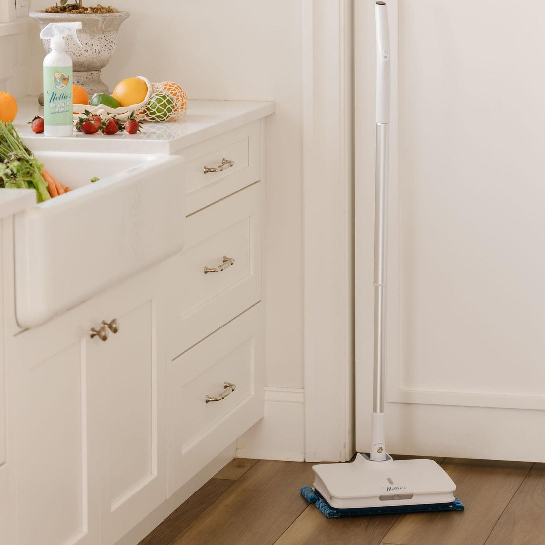 Fruit and vegetable wash and fruit on counter with electric mop on floor