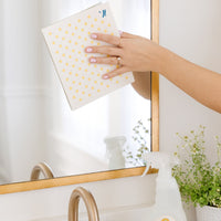 Cleaning a mirror with polka dot Swedish Dishcloth